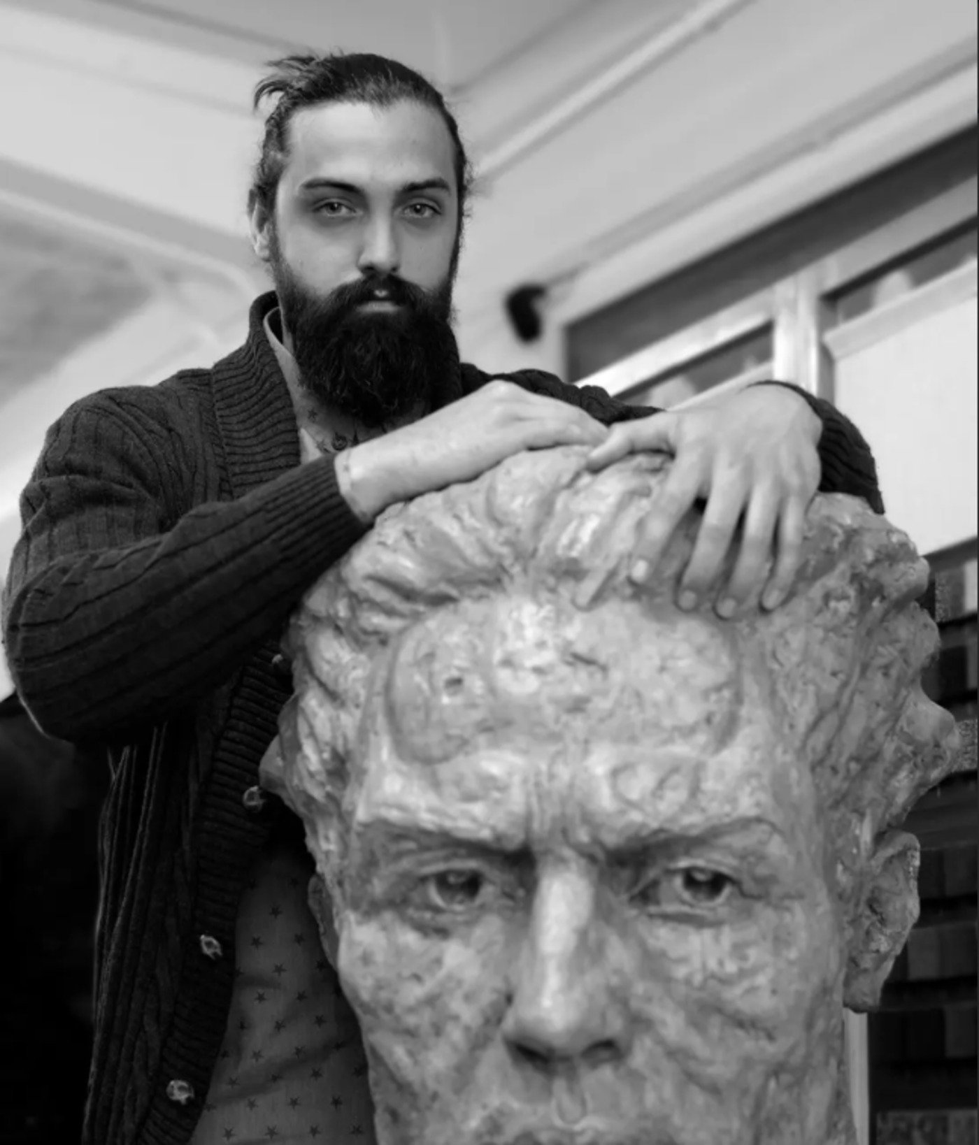 Portrait of the sculptor with a plaster bust in progress